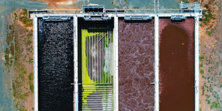 Drone footage shows the color variation of many different microbial systems at work within a wastewater treatment plant aeration pond system. (Image: Shutterstock)