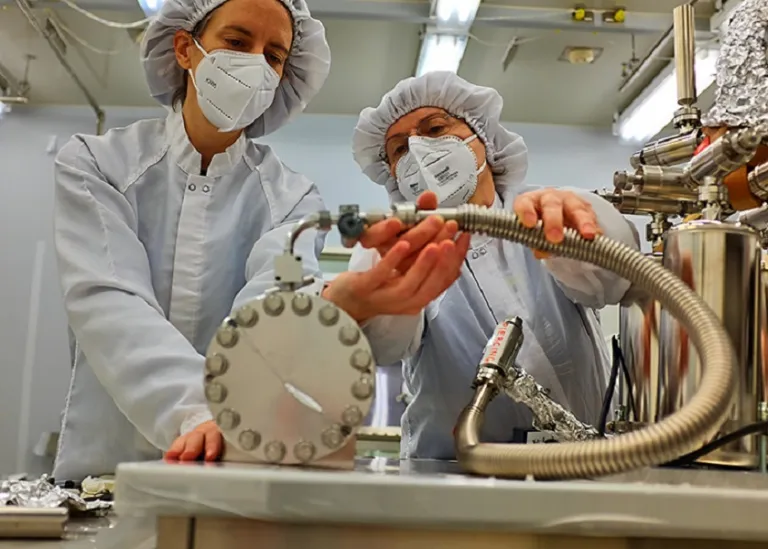 Olga Pravdivtseva, right, helps adjust the extraction manifold apparatus at Johnson Space Center in Houston. (Photo: Alex Meshik)