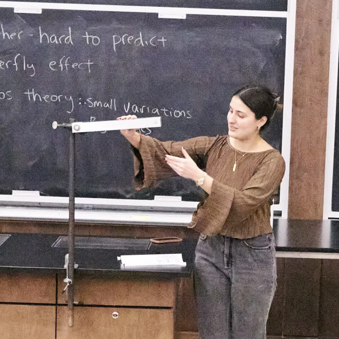 Grad student demonstrates the double pendulum or "chaos pendulum" at Physis Family Fun Day